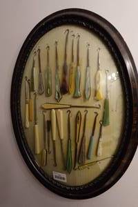 lot 131 image: Antique Button Hook Collection in Oval Frame - Plastic Handles