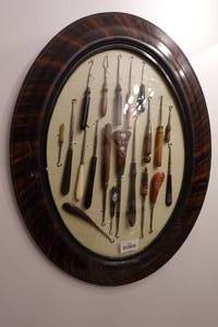 lot 132 image: Antique Button Hook Collection in Oval Frame - Wood Handles