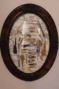 lot 137 image: Antique Button Hook Collection in Oval Frame - Shoe Horn Handles