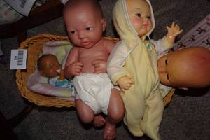 lot 394 image: Baby Dolls with Wicker Bassinet