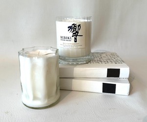 lot 264 image: Pair of Upcycled LIQUOR BOTTLE Soy Candles and Decorative White Books with Calligraphic Cover