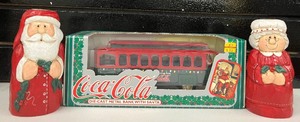 lot 55 image: Coca Cola Die Cast Metal Bank Train with Santa NIB and Mr. & Mrs. Clause Candles
