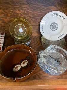 Vintage ashtrays, winchester belt buckle and misc