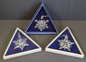 lot 108 image: Three Swarovski Crystal Snowflake Ornaments including a Swarovski 2001 Crystal Snowflake Ornament