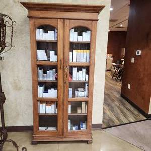 lot 59 image: Compact Antique Solid Wood Bookcase Cupboard Cabinet with Arching Glass-Paned Doors Measuring 39-14 inches W by 18-14 inches D by 76 inches H. Bookcase Only, Contents not included.