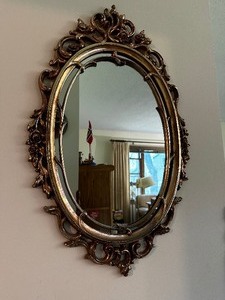 lot 115 image: Vintage Gold Oval Syroco Ornate Framed Mirror Measuring 18 Inches by 29 Inches. Estimated Value $100
