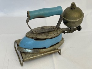 lot 39 image: Antique Coleman Instant Lite Iron with Cooling Stand. Estimated Value $60-120