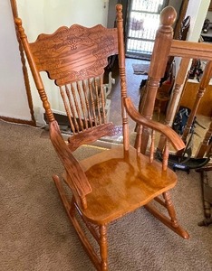 lot 57 image: Solid Wood Hand Carved Vintage Rocking Chair. Estimated Value $400-550. Measuring 43 Inches by 23 Inches by 33 Inches.