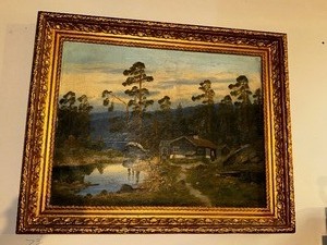 lot 505 image: Oil Painting of Cabin by Lake in Ornate Frame, Measuring 32 x 24 Inches.