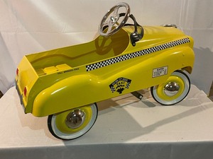 lot 511 image: Full Size Childs Peddle Car New York City Checker Taxi Vintage Replica Measuring approx 35. Estimated Value $350-375