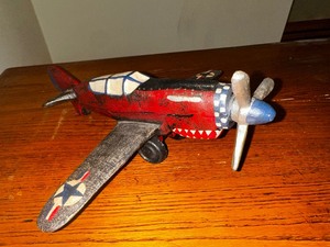 lot 353 image: Vintage cast iron P 40 Warhawk fighter plane measuring 10 inches long by 10 inches wide
