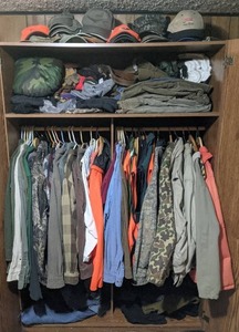 lot 99 image: Large Assortment of Mens Clothing Hats, Button-Up Shirts, Tops, Pants, Belt, Etc.