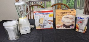 lot 78 image: New Presto Power Pop, Presto Bread Slicing System, Zyliss Switzerland Chopper, Blender, and Plastic Containers