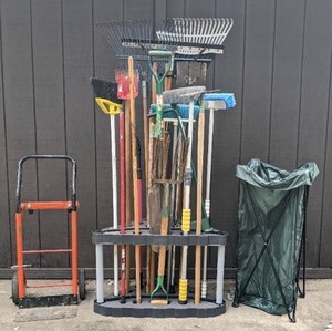 lot 58 image: Lawn & Garden Tools Rakes, Shovels, Spades, Brooms, Pitchfork in Tool Holder, Dolly, Lawn & Leaf Bag with Stand
