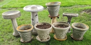 lot 46 image: (2) Stone Bird Baths, Bird Bath Bases (1) Stone & (1) Plastic, Planters (3) Foam, (2) Clay or Stone, and (5) Rolling Planter Bases