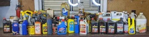 lot 59 image: Household and Automotive Fluids Motor Oil, STP, Minwax Stain, Fast Orange Hand Cleaner, Shellac, Windex, Muriatic Acid, and More