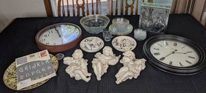 lot 95 image: (2) Wall Clocks, (3) Musical Cherub Dcor, DecoArt Letters, Glass with Gold Rim Bowls & Plates, Etched Glass Teacup, (2) 3D Plates, Decorative Tin Box, Etc.
