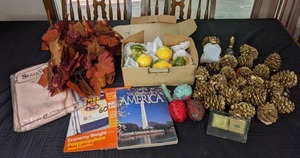 lot 52 image: Home Decor Items Gold Pinecones, Ceramic Lemons, Tablecloth, Fall Leaves, Vintage Avon Perfume Bottles, and More