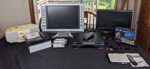 lot 90 image: New Bell South Caller ID with Call Waiting, Sylvania HDMI Upconvert DVD Player, Sony Cassette CD Player, Sylvania LCD TVs, Zinwell Digital to Analog Converter Box, Fisher DVD Player, RCA Digital TV Converter, Etc.