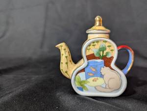 lot 111 image: Miniature Cat and Fish Themed Ceramic Teapot