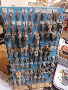 lot 16 image: 2 sided spinning key display with internal storage full of NOS key blanks