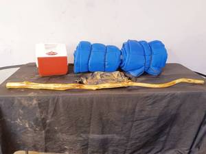 lot 49 image: Two sleeping bags, playmate cooler, diamond willow walking stick,  camo bag.