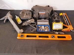lot 75 image: Dremel tool with accessories, level, caulking guns