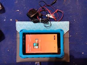 lot 60 image: Amazon fire tablet with charger, case, ear buds, and bag