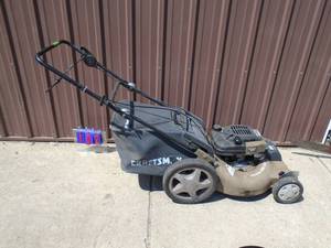 lot 102 image: Craftsman self propped 6.75 hp mower with bag. Tested & works. Needs clean up. As shown.