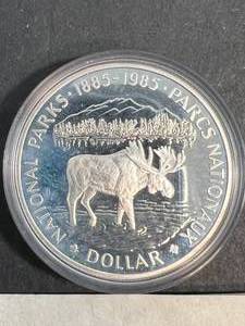 lot 65 image: 1985 CANADIAN MOOSE SILVER DOLLAR IN AIRTITE
