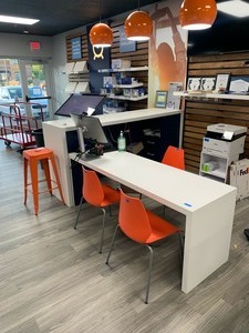 Corian Desk, Front counter, filing cabinet built in, 3 orange chairs, one barstool