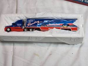 lot 73 image: ERTL Ford Quality Care Racing Transporter Scale Die-Cast Model