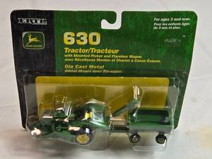 lot 92 image: Ertl John Deere 630 Tractor w Mounted Picker and Flarebox Wagon Die-Cast Model