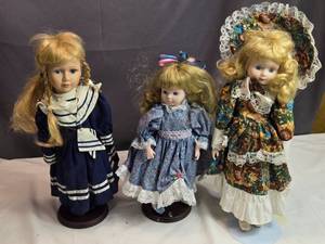 lot 167 image: Trio of Porcelain Dolls in Victorian Dresses with Stands