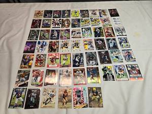 lot 209 image: Lot of 60 NFL Stars Cards Including Joe Montana, Jalen Hurts, JJ Watt, Nick Bosa, Lawrence Taylor and More