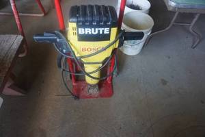 lot 10 image: Bosch Brute Electric Jack Hammer With 2 Bits and 2 Wheel CartDolly