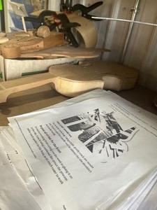 lot 18 image: start to a hand made Violin with parts and instructions