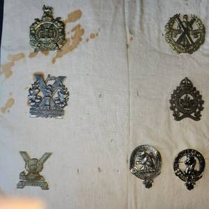 lot 23 image: collection of Scottish Kilt pins, Clan Crests, regimental pins from Davids many characters.