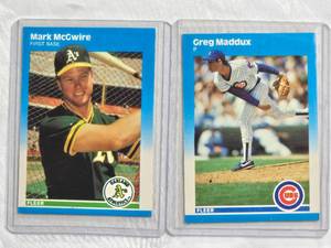 lot 108 image: Lot of 2 - Greg Maddux Rookie 1987 Fleer #U-68 & Mark McGwire Rookie 1987 Fleer #U-76