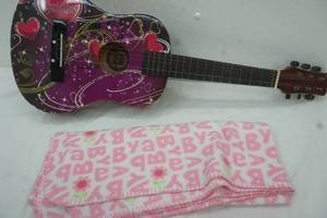 lot 137 image: Guitar and baby blanket