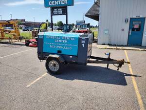 lot 22 image: Airman Portable Diesel Trailer Air Compressor Started right up. Model PDS185S.