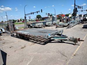 lot 57 image: 2006 Redi-Haul 8x18 Flatbed Trailer 2 channel equipment ramps. Chains. Model R18252FS