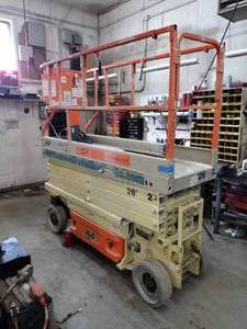 lot 12 image: JLG 2630ES Scissor Lift, 26 deck height.  30  wide. Powers Up