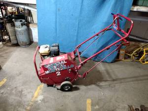 lot 65B image: Classen Aerator. Pulls out a 2 plug. 18 wide path. Self-propelled.  Gas Honda engine GX120. Engine starts up