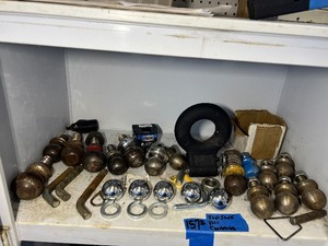lot 157B image: Shelf of hitch balls, forged pintle eyes, Hitch pins, lock nut