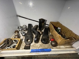 lot 158B image: Shelf of hitch balls, forged trailer hitch mounts, Hitch pins, lock nuts.