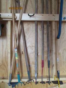 Lot of assorted garden hoes and weed tools