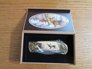 Commemorative folding knife in a wo...
