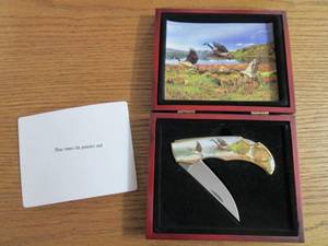 Commemorative folding knife in a wo...