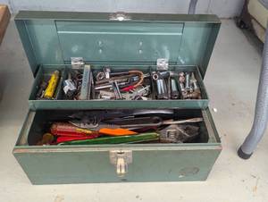 Green metal toolbox containing a la...